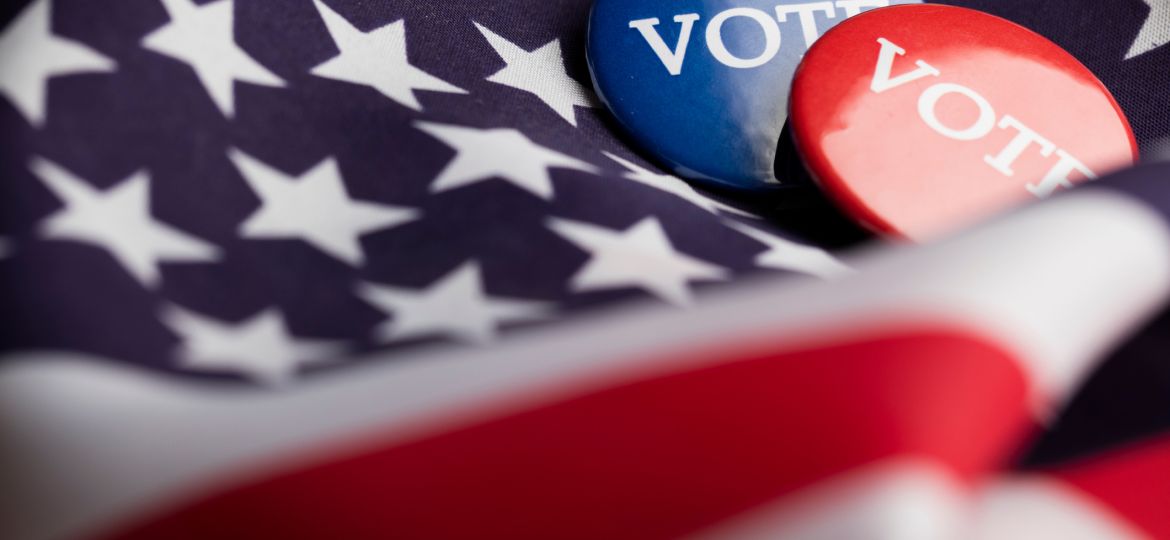USA election vote button on a stars and stripes flag