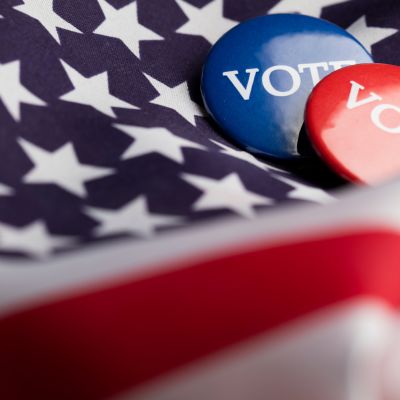 USA election vote button on a stars and stripes flag
